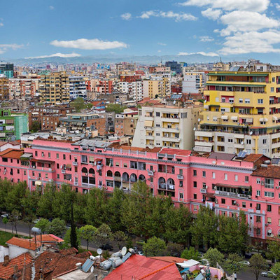 A skyline view of Tirana with many colourful, multi-storey buildings