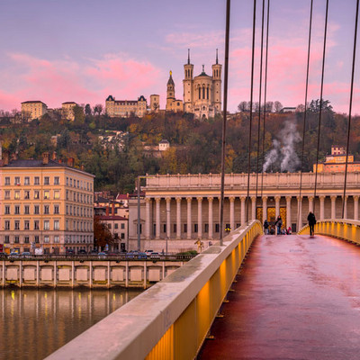 Bonaparte Bridge in Lyon at sunset with Fourvière Basilica and the metal tower in the background