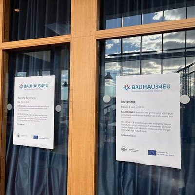 BAUHAUS4EU posters on a glass wall announce the opening ceremony and invitation.