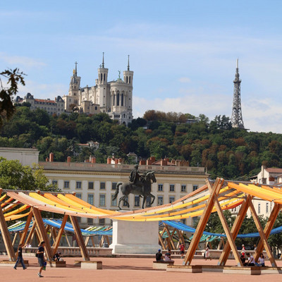Place Bellecour in Lyon with the statue of Louis XIV, the Basilica of Fourvière and the metal tower in the background